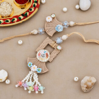 “Handmade Bhaiya-Bhabhi Rakhi set featuring woven basket-style design, floral embellishments, pastel pearls, and a decorative Rakhi thali with kumkum and chawal.”