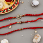Traditional 3 Bhaiya Rakhi Set with Rudraksh beads, Om charms, red moli threads, decorative Kumkum-Chawal thali, greeting card, and chocolate.