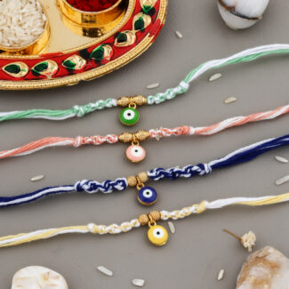 Colorful Evil Eye Bhaiya Rakhi Set with vibrant threads, protective evil eye beads, kumkum-chawal thali, greeting card, and chocolate.